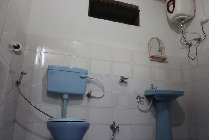 Bathroom of our lamahatta druk homestay, it has a western toilet, shower and geyser or water heater